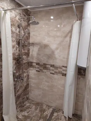 a bathroom with a shower with a glass door at Familia Apartments in Samokov