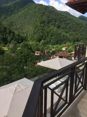a balcony with a view of a mountain at Терасите - Къща 3 in Ribarica