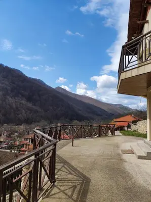 a balcony of a building with a view of a mountain at Терасите - Къща 3 in Ribarica