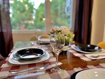 a table with plates and a wine glass on it at Tranquil Retreat in the Heart of Sofia: 2BR in Sofia