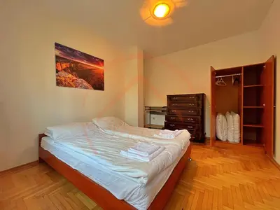 a bedroom with a bed and a dresser in it at Tranquil Retreat in the Heart of Sofia: 2BR in Sofia