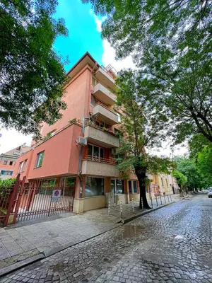 a red building on the side of a street at Tranquil Retreat in the Heart of Sofia: 2BR in Sofia