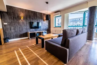 a living room with a couch and a tv at On the top! in Sofia