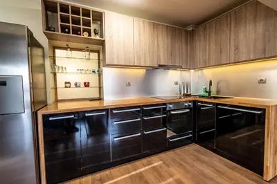 a kitchen with wooden cabinets and a stainless steel refrigerator at On the top! in Sofia