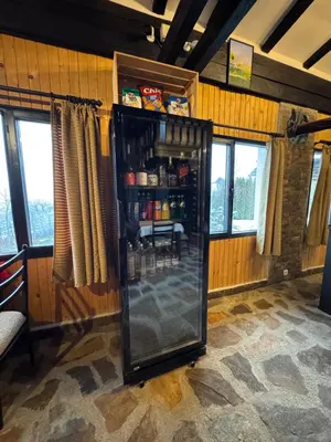 a refrigerator filled with drinks in a room with windows at СТАРАТА КЪЩА in Sovolyano
