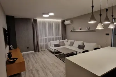 a living room with a white couch and a table at Mila's Cozy 1 Bedroom Apartment in Sofia