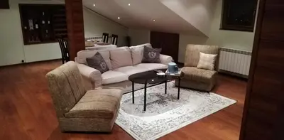 a living room with a couch and two chairs and a table at Classic Hotel in Sofia
