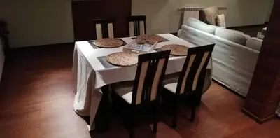 a dining room table with two chairs and a couch at Classic Hotel in Sofia