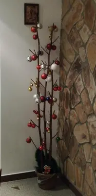 a christmas tree in a pot next to a stone wall at Classic Hotel in Sofia