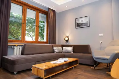 a living room with a couch and a coffee table at Central Sofia 3-bedroom apartment - Urban Art gallery - Free Parking! in Sofia