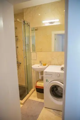 a bathroom with a washing machine and a sink at Central Sofia 3-bedroom apartment - Urban Art gallery - Free Parking! in Sofia