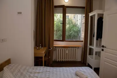a bedroom with a bed and a sink and a window at Central Sofia 3-bedroom apartment - Urban Art gallery - Free Parking! in Sofia