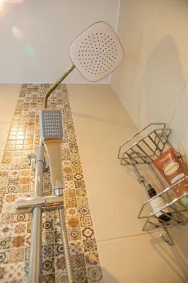 a bathroom with a sink with a shower head at Central Sofia 3-bedroom apartment - Urban Art gallery - Free Parking! in Sofia