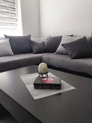 a living room with a couch and a table at Апартамент Слави in Blagoevgrad