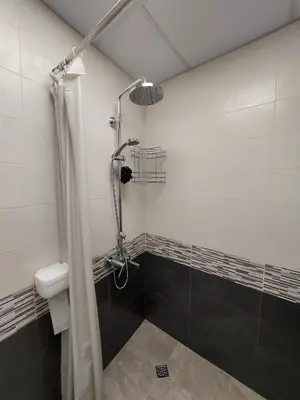 a bathroom with a shower with a glass door at Апартамент Слави in Blagoevgrad