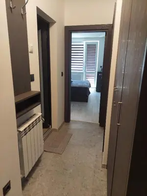 a hallway with a room with a bed and a door at Апартамент Слави in Blagoevgrad