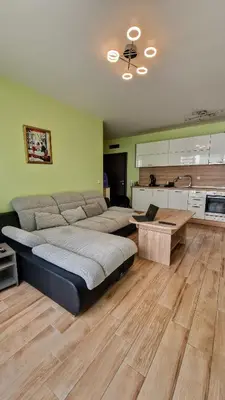 a large bedroom with a bed and a table at Little City Retreat in Sofia