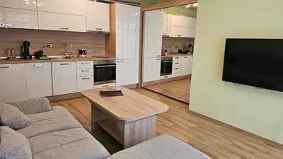 a living room with a couch and a table and a tv at Little City Retreat in Sofia