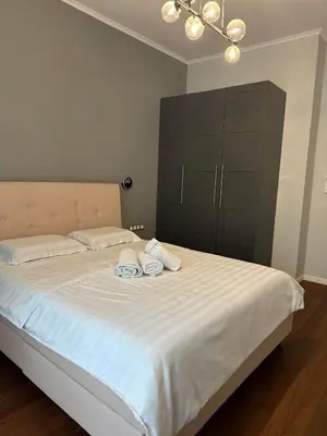 a bedroom with a bed with two towels on it at Sofo house in Sofia
