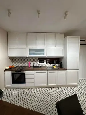 a kitchen with white cabinets and a counter top at Sofo house in Sofia