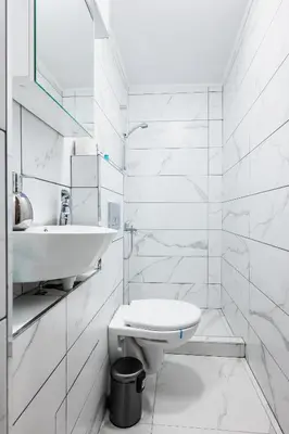 a white bathroom with a sink and a toilet at 1BD Elegance on Vasil Levski Boulevard by Flat Mаnager in Sofia