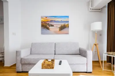 a living room with a couch and a table at 1BD Elegance on Vasil Levski Boulevard by Flat Mаnager in Sofia
