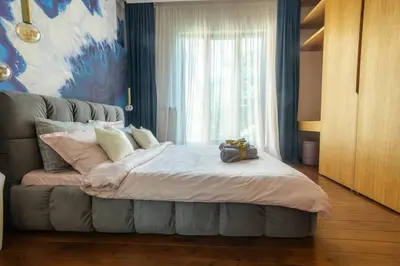 a bedroom with a large bed with a window at Top Central Design, 2 Bedroom, NDK, FREE Secured parking in Sofia