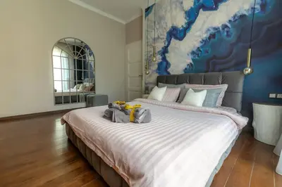 a bedroom with a large bed with a blue wall at Top Central Design, 2 Bedroom, NDK, FREE Secured parking in Sofia