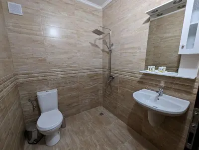 a bathroom with a toilet and a sink at Апартамент Габи in Karlovo