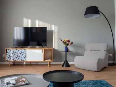 a living room with a tv and a chair at Central Apartment Parking Two Bedrooms Sky Terrace in Sofia