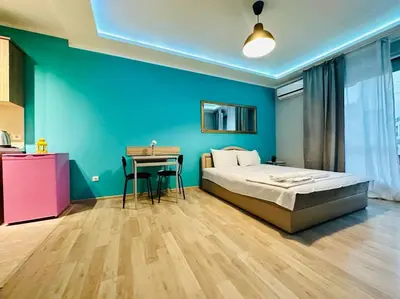 a bedroom with a bed and a desk in it at Barbie Studio in Sofia