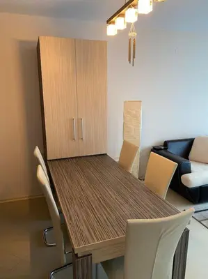 a dining room with a wooden table and chairs at Lovely 1-bedroom appartment in Sofia near Vitosha in Sofia