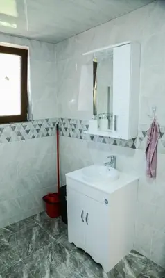 a white bathroom with a sink and a mirror at Къща за гости Хаджиеви in Ognyanovo