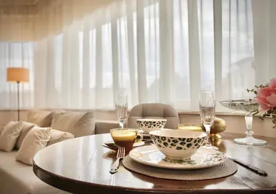 a table with plates and wine glasses on it at Sunny & Cozy Apartment for 4 Guests & Free Parking in Plovdiv