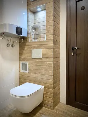 a bathroom with a toilet and a wooden door at Sunny & Cozy Apartment for 4 Guests & Free Parking in Plovdiv
