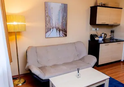a living room with a couch and a table at private apartment in a five-star hotel in Bansko in Bansko