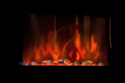 a fire in a fireplace with lots of flames at private apartment in a five-star hotel in Bansko in Bansko
