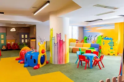 a childrens play room with colorful chairs and tables at private apartment in a five-star hotel in Bansko in Bansko