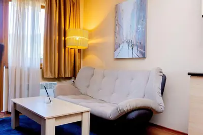 a living room with a couch and a table at private apartment in a five-star hotel in Bansko in Bansko