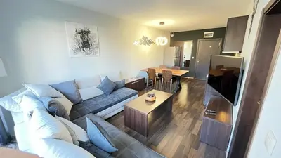 a living room with a couch and a table at ALTITUDE MOUNTAIN APARTMENTS ASPEN at GONDOLA BANSKO in Bansko