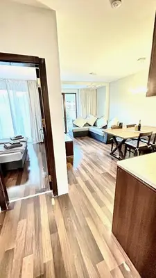 a living room with a couch and a table at ALTITUDE MOUNTAIN APARTMENTS ASPEN at GONDOLA BANSKO in Bansko