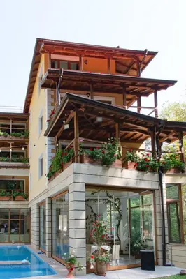 a building with a swimming pool and a house at Hotel Saint Nedelya in Kolarovo