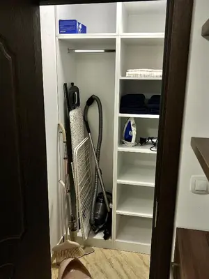 a closet with a fan and other items in it at Ultra Lux Apartment Free Underground Secure Parking in Pazardzhik
