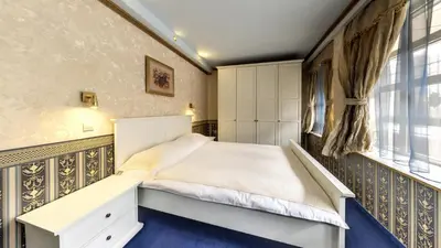 a bedroom with a bed and a window at Hotel Boyana in Sofia