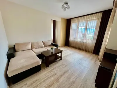 a living room with a couch and a table at Hani Guest House in Garmen
