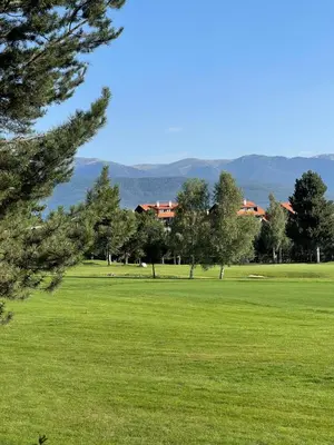 a green field with trees and buildings in the background at Apartament by Zenit in Terra Complex C30 in Razlog