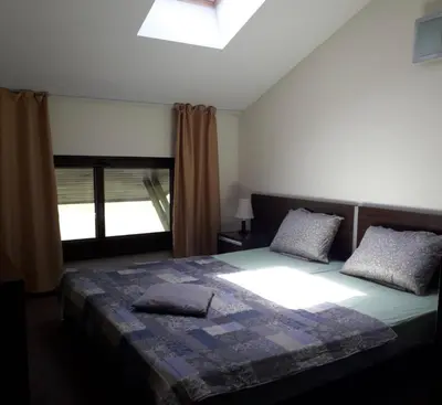 a bedroom with a large bed and a window at Apartament by Zenit in Terra Complex C30 in Razlog