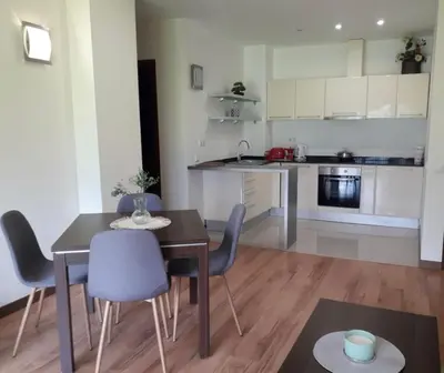 a kitchen and dining room with a table and chairs at Apartament by Zenit in Terra Complex C30 in Razlog