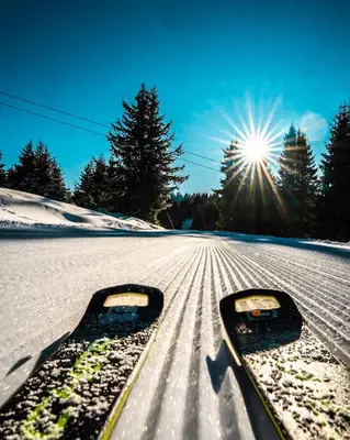 a pair of skis in the snow with the sun at Panorama View-Stoykite in Stoykite
