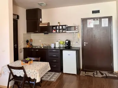 a kitchen with a table and a small kitchen with a sink at Ski Lift Studio 531 in Bansko